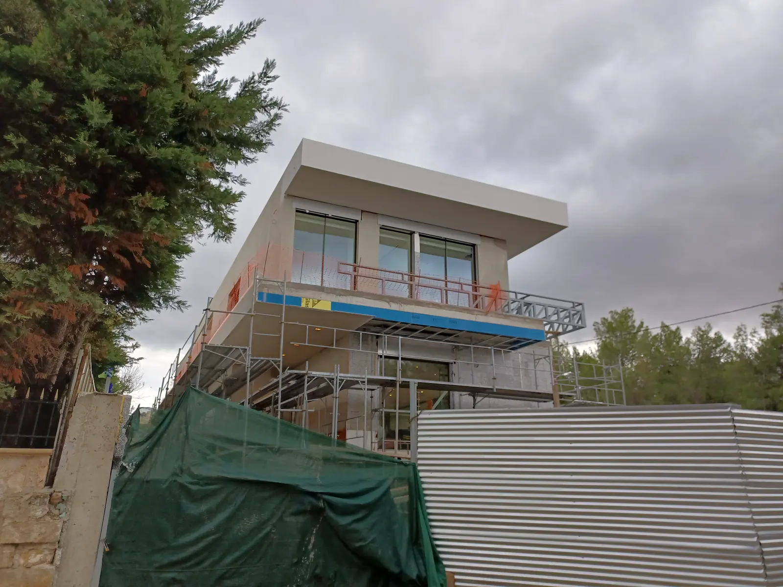Completed two-storey concrete house with cantilevered upper floor